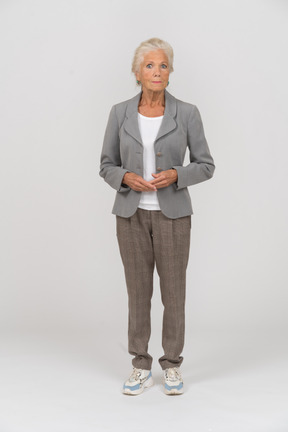 Front view of an old woman in suit looking at camera