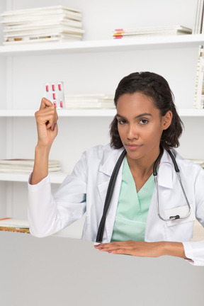 A doctor holding up a pill blister