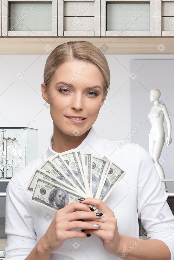 A woman holding a bunch of money in her hands