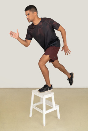 Young man in sports clothes exercising