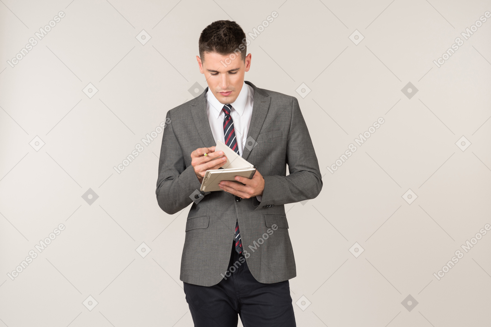 Young reporter reading something written in the notebook