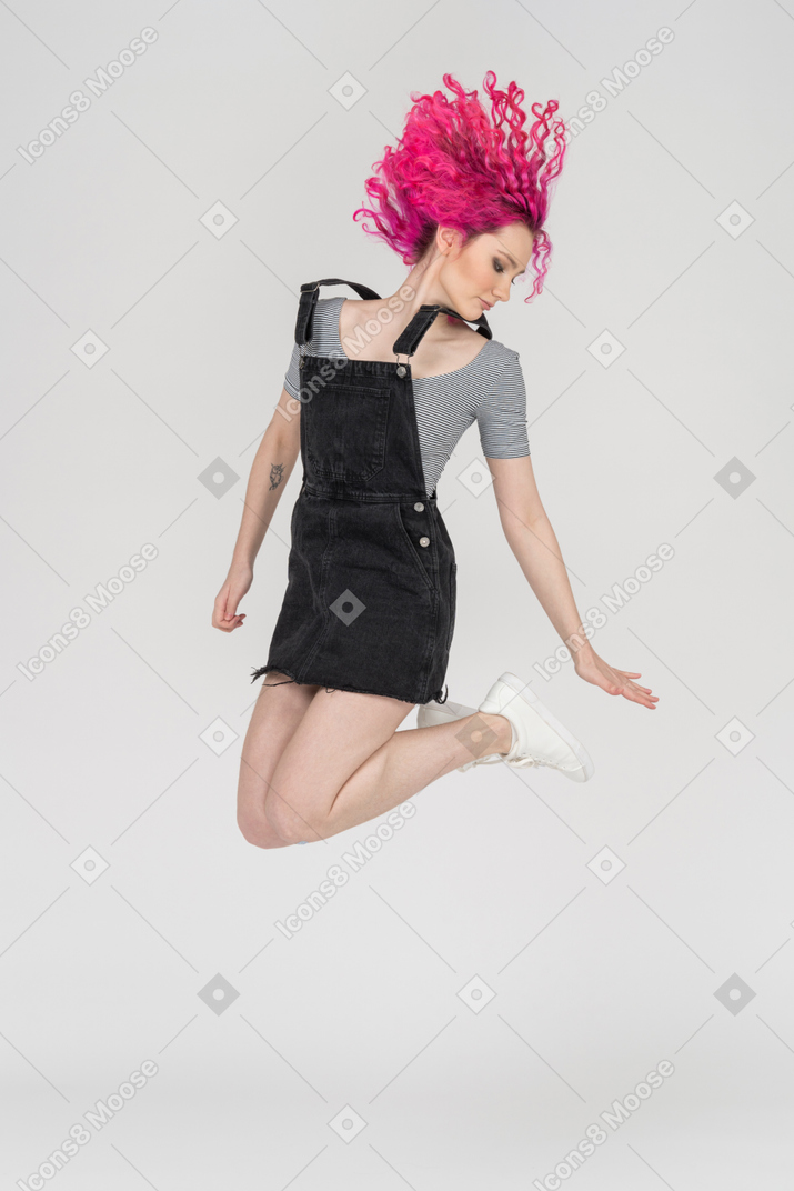 A pink haired girl jumping up