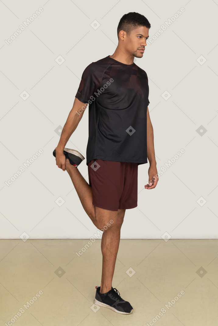 Young man in sports clothes exercising
