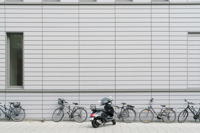 Bicycles and scooter parked in front of building