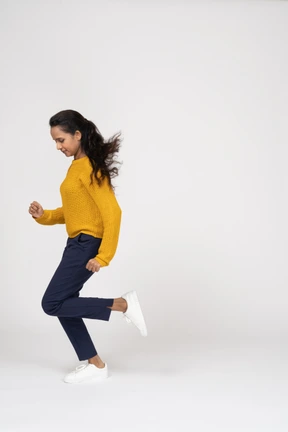 Side view of a girl in casual clothes running