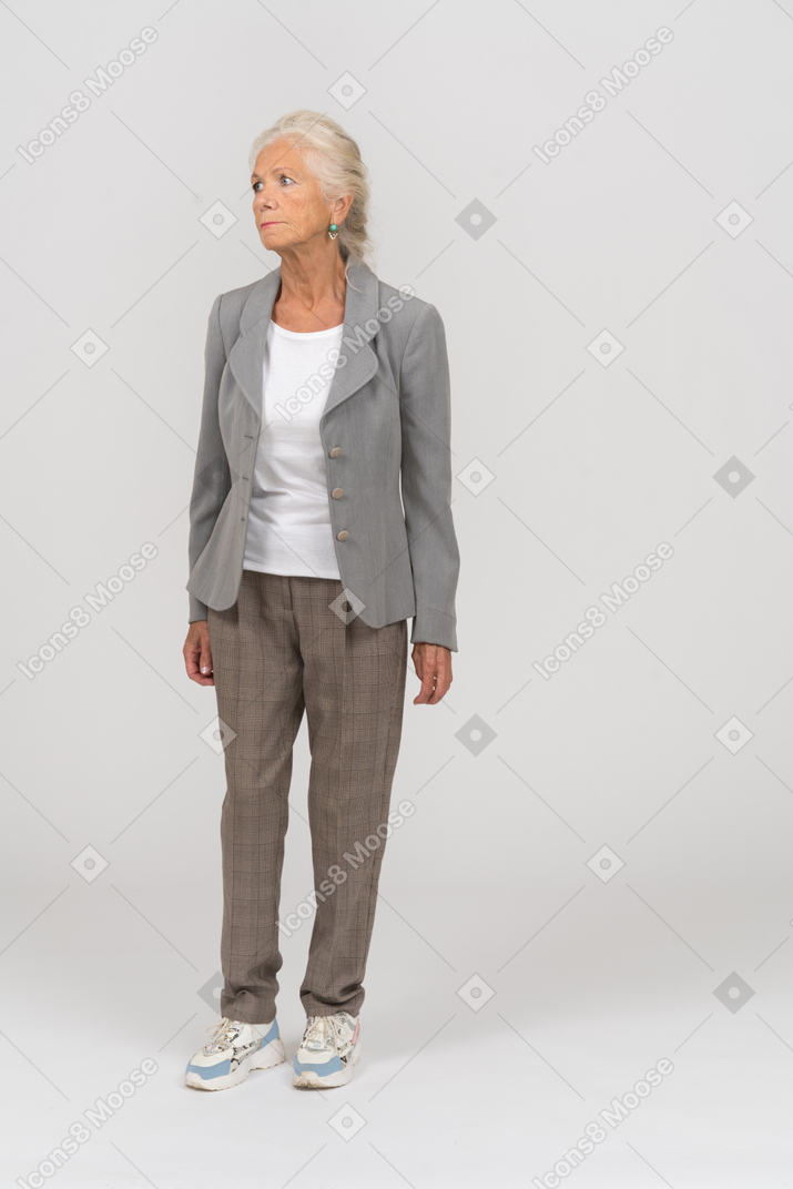 Front view of an upset old woman in suit