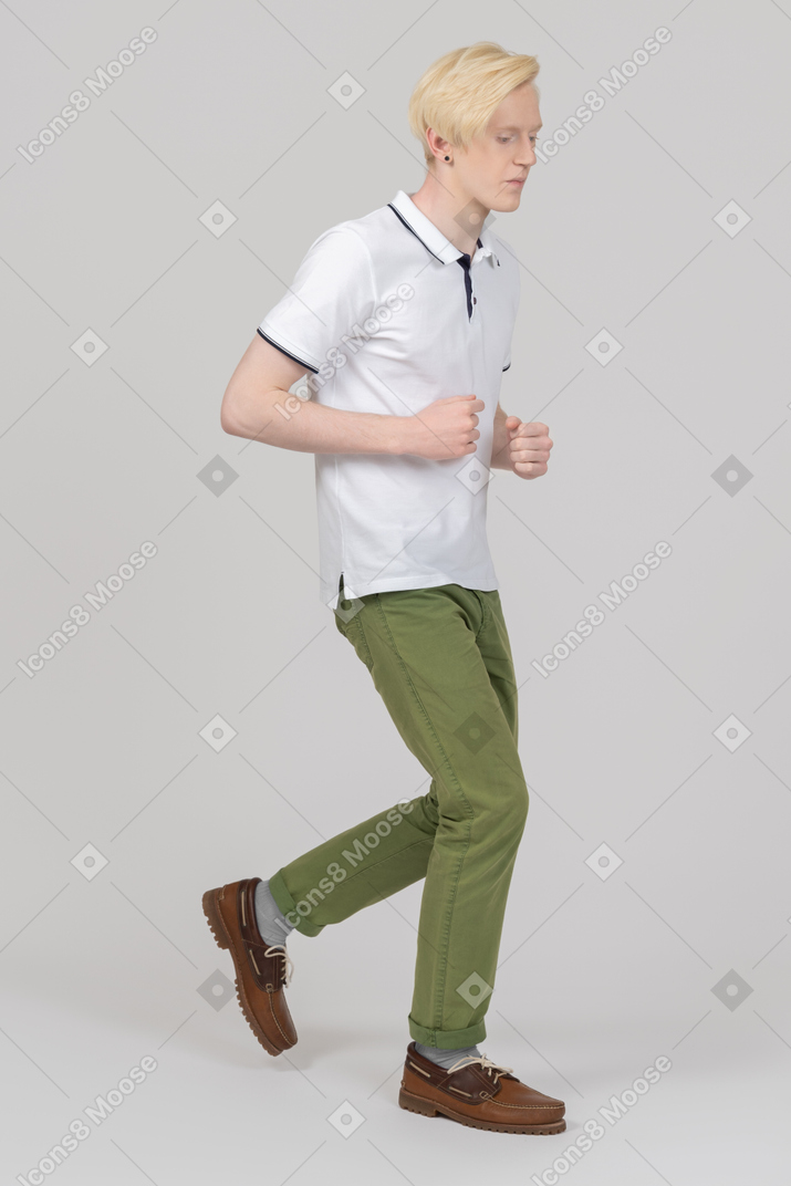 Young man running while looking down