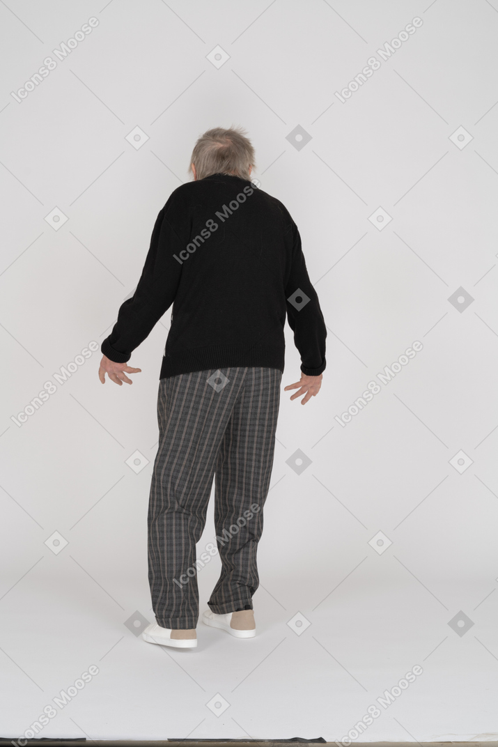 Back view of old man with spread arms