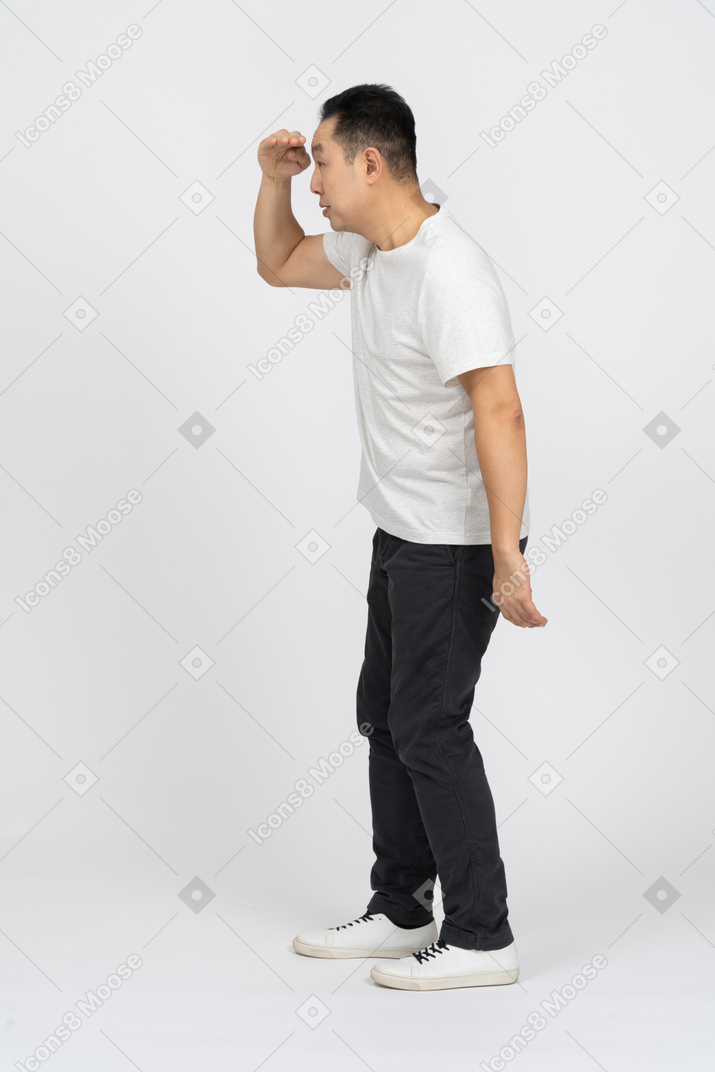 Side view of a man in casual clothes looking for someone
