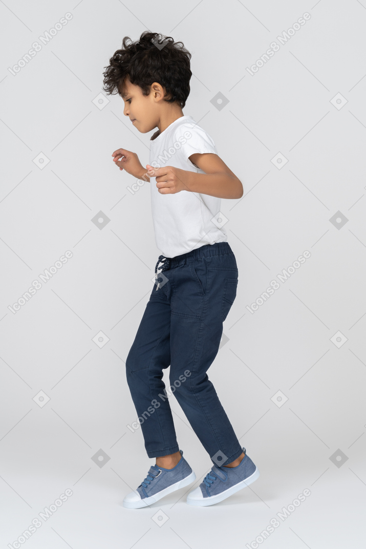 A boy walking on toes