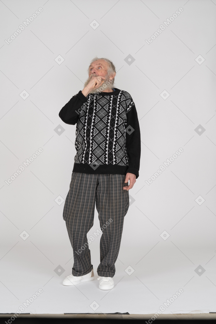 Old man looking up with hand at face