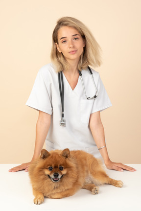 Attractive veterenarian ready to examine a spitz