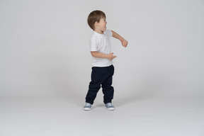 Cheerful little boy moving his arms around