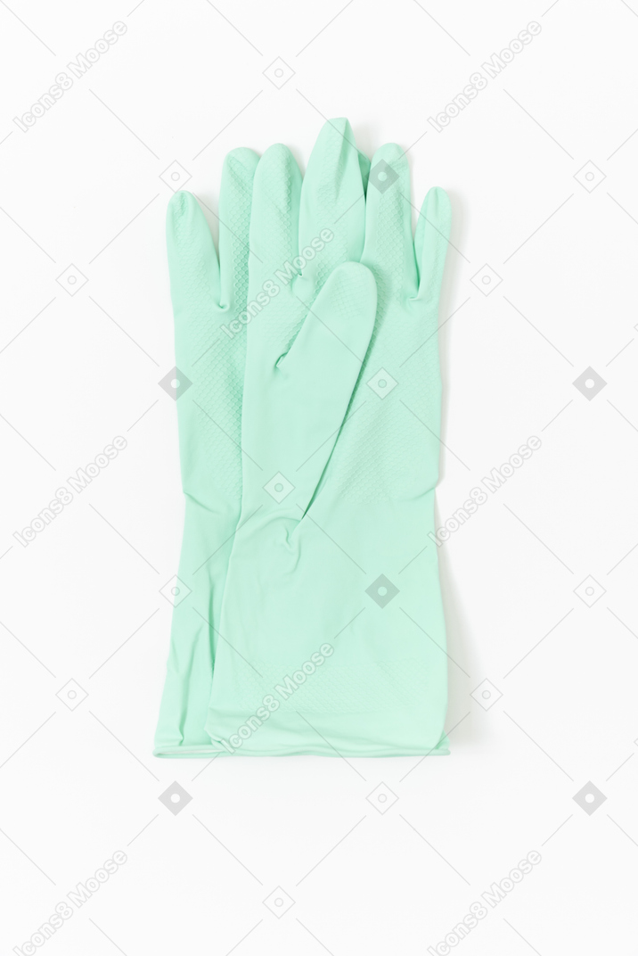 Light blue rubber gloves lying on the plain white background