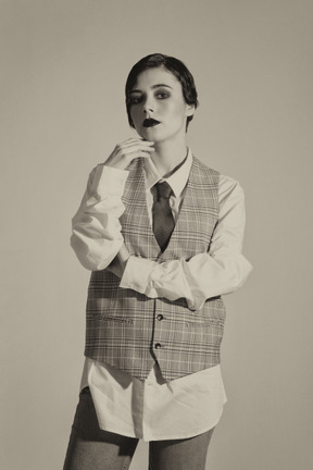 Beautiful retro-styled woman posing in checkered vest