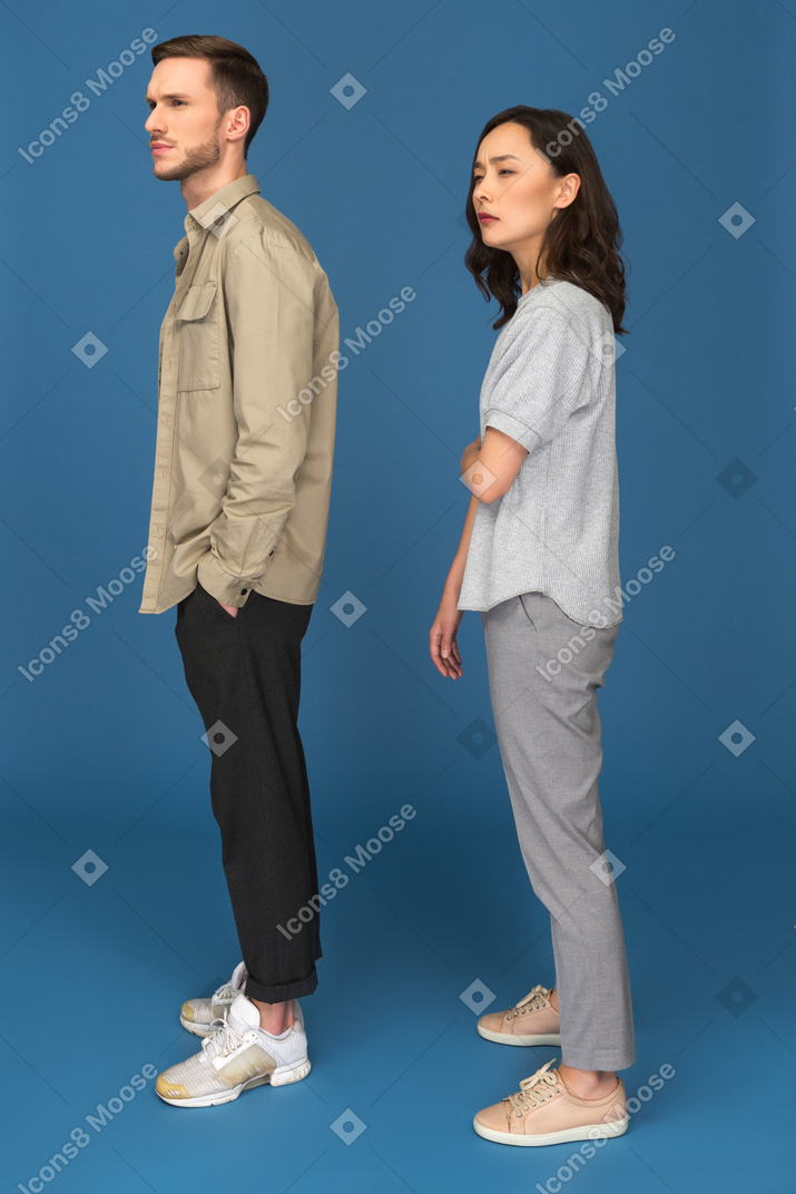 Concerned man and woman staring at corner