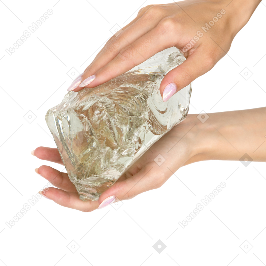 Cropped photo of hands holding glassy rock