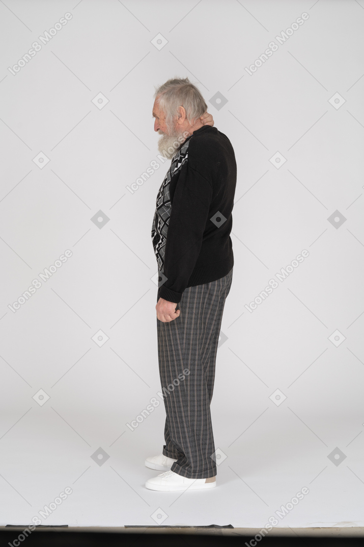 Side view of old man with hand on neck