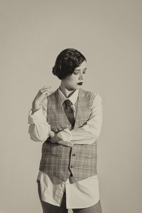 Beautiful retro-styled woman posing in checkered vest