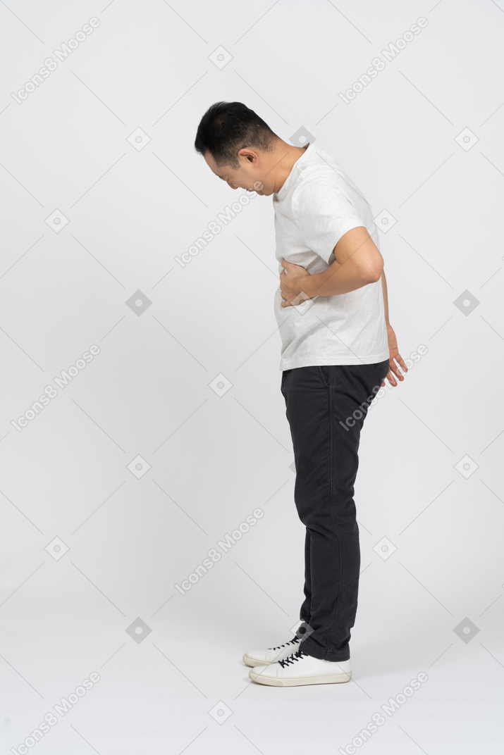 Side view of a man suffering from stomachache