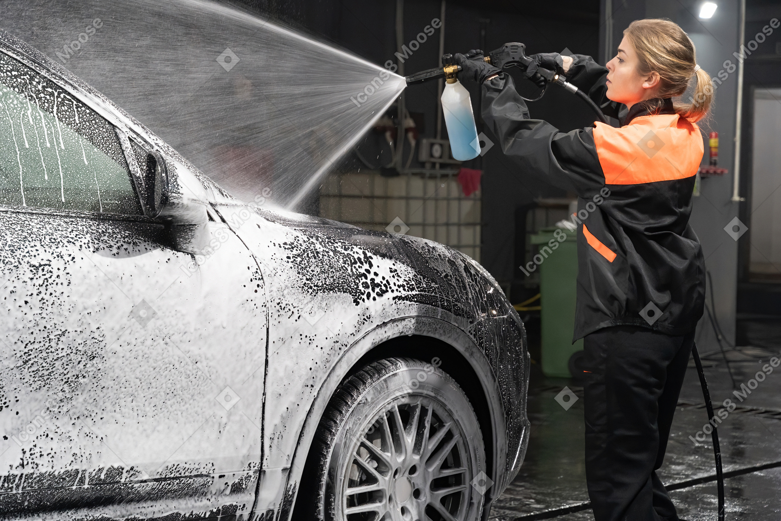 Young woman washing car
