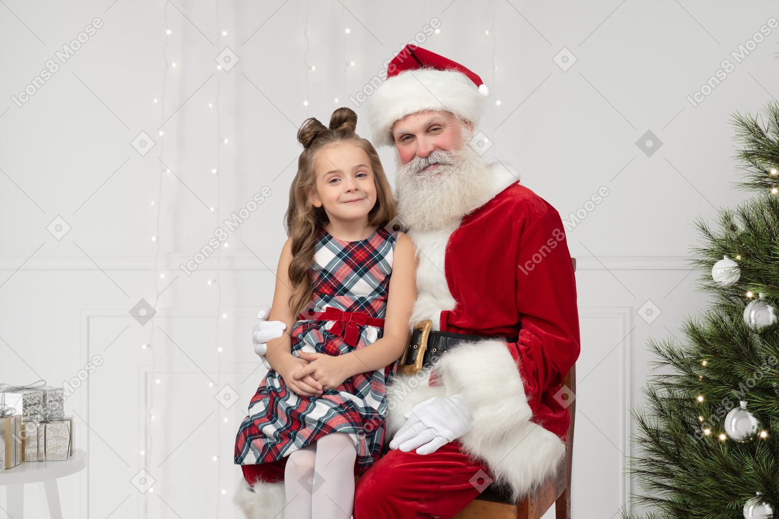 Happy girl sitting on santa's knees