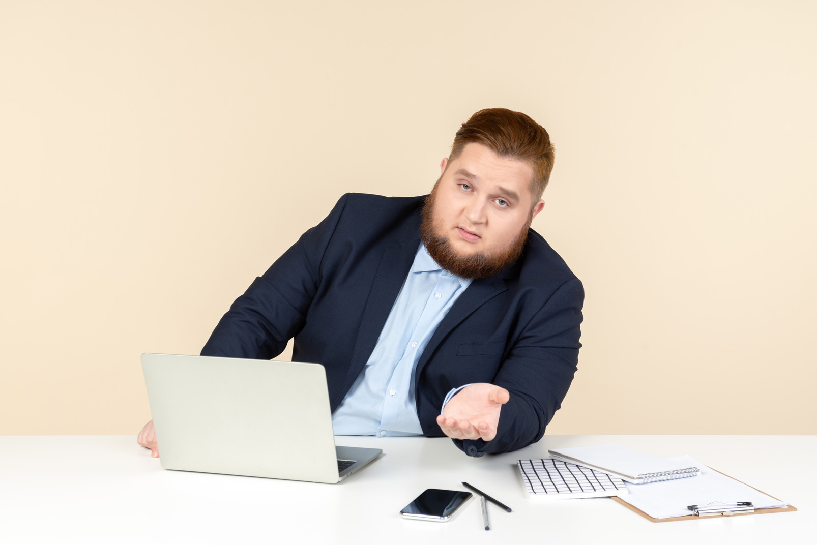 Young overweight man sitting at the desk and like talking about something