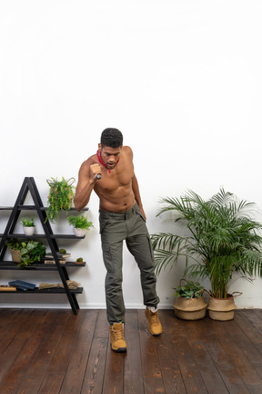 Good looking athletic man holding flashlight