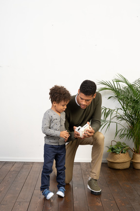 Young man on knees with a boy.