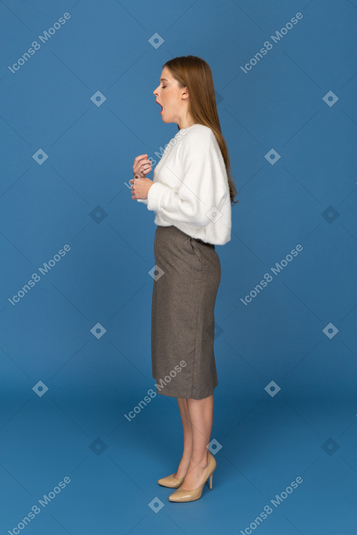 Young businesswoman yawning