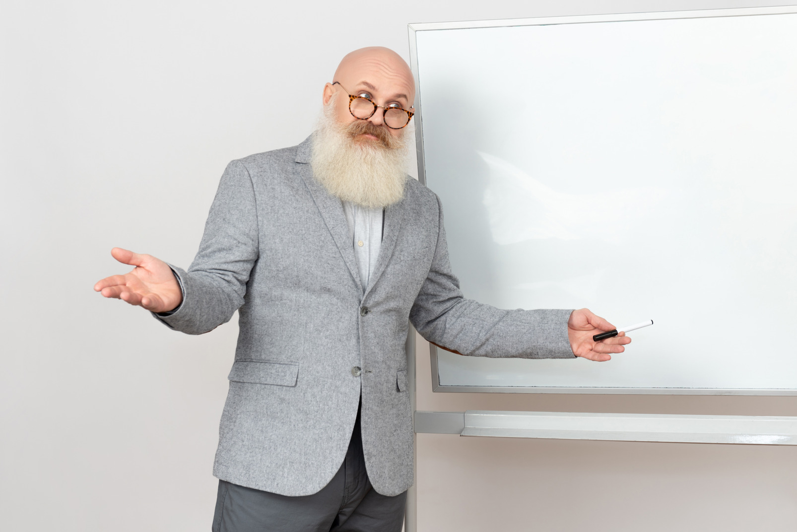 Old professor standing next to whiteboard and explaining something