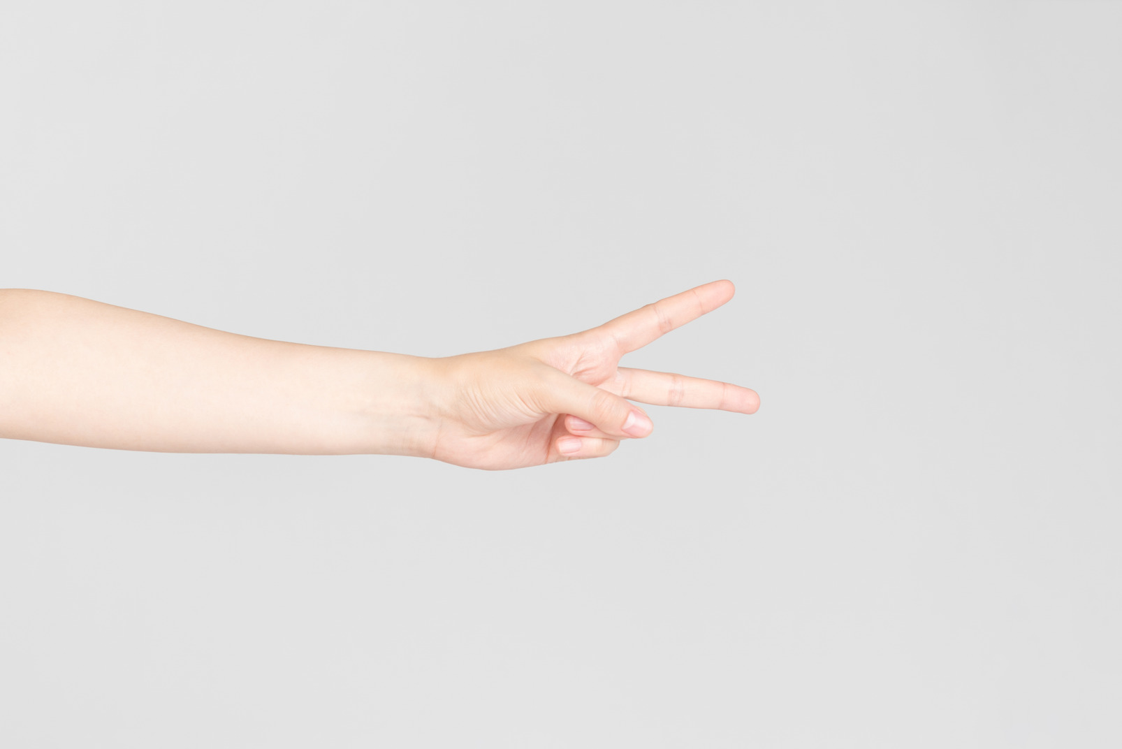 Female hand showing v sign horizontally