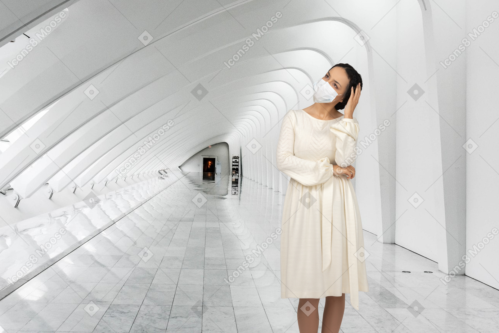 Woman wearing face mask and standing in hallway