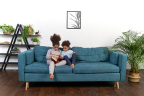 Cute boy and girl reading the book