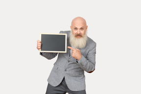 Old professor holding small blackboard