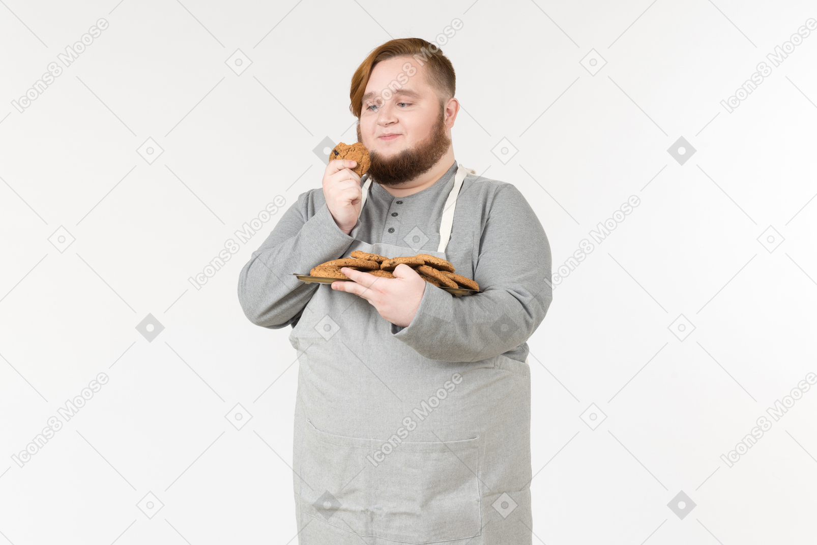 A fat man looking with love at a cookie