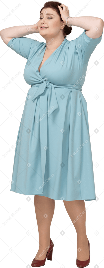 Front view of a woman in blue dress touching head