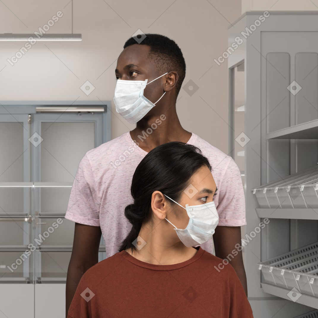 A man and a woman wearing face masks