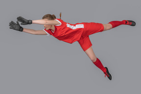 A female goalkeeper in the air