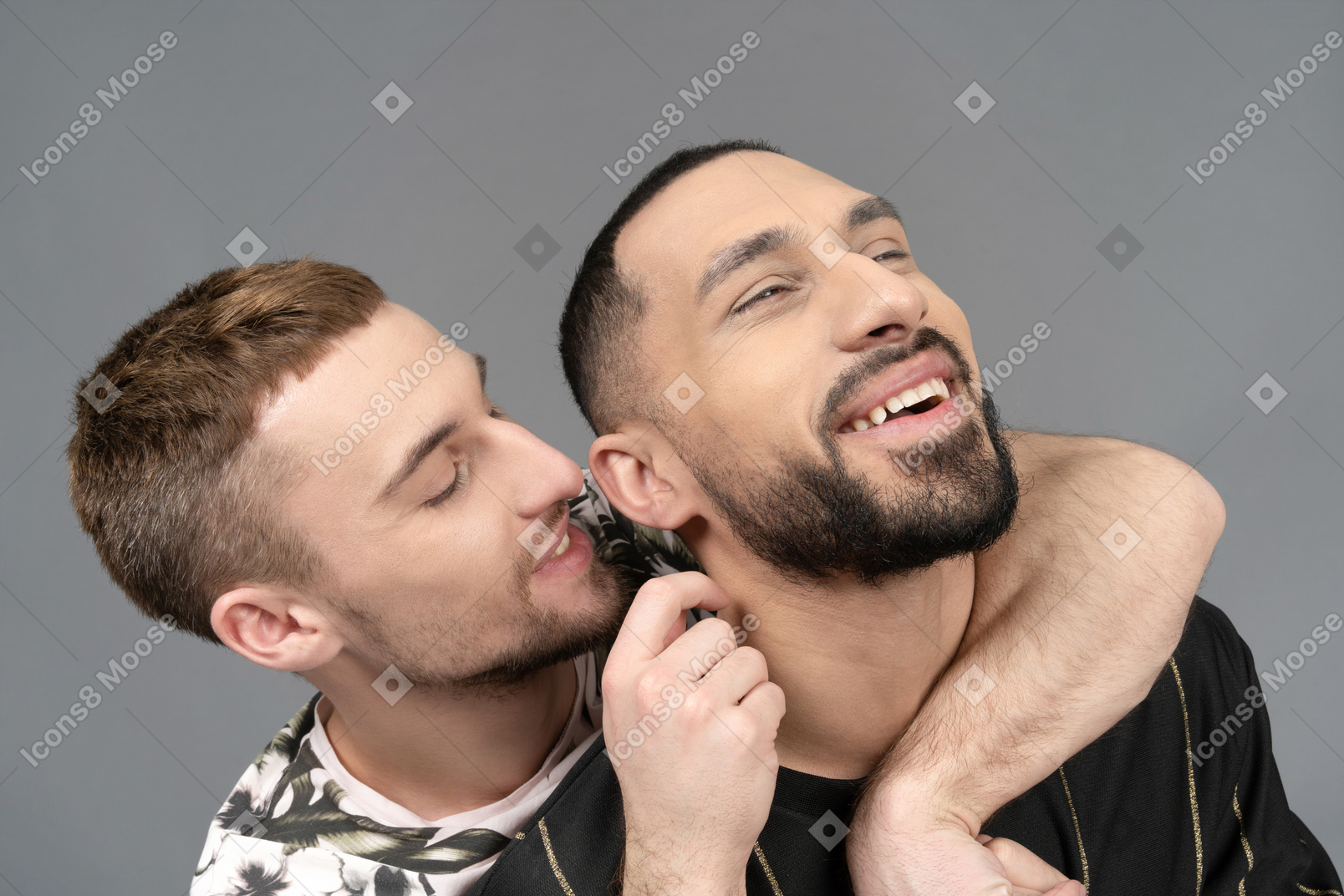 Portrait of a young man tickling his partner's neck while laughing