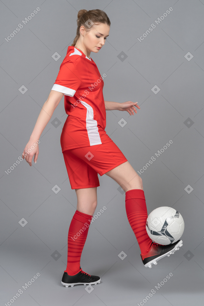 Holding a football ball on a foot