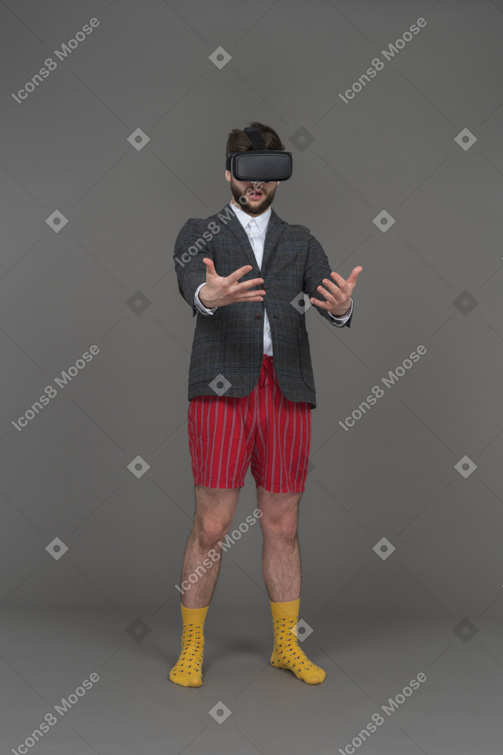 Man in vr headset is looking at his hands