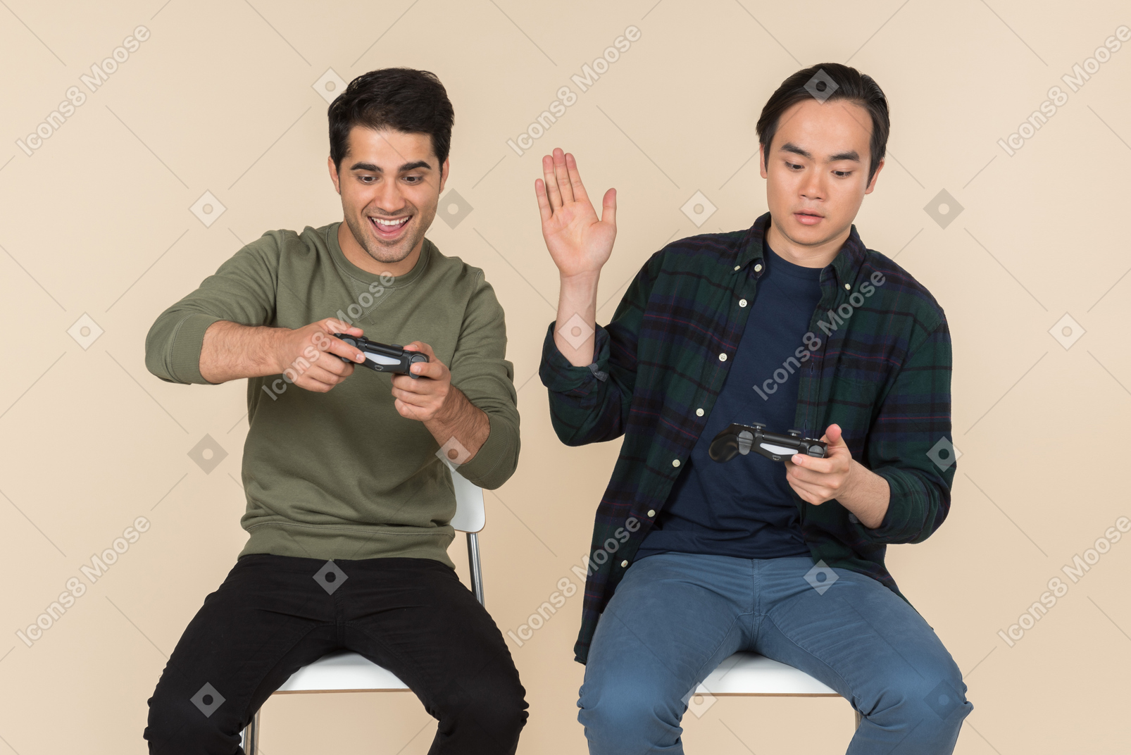 Interracial friends sitting in chairs and playing video game