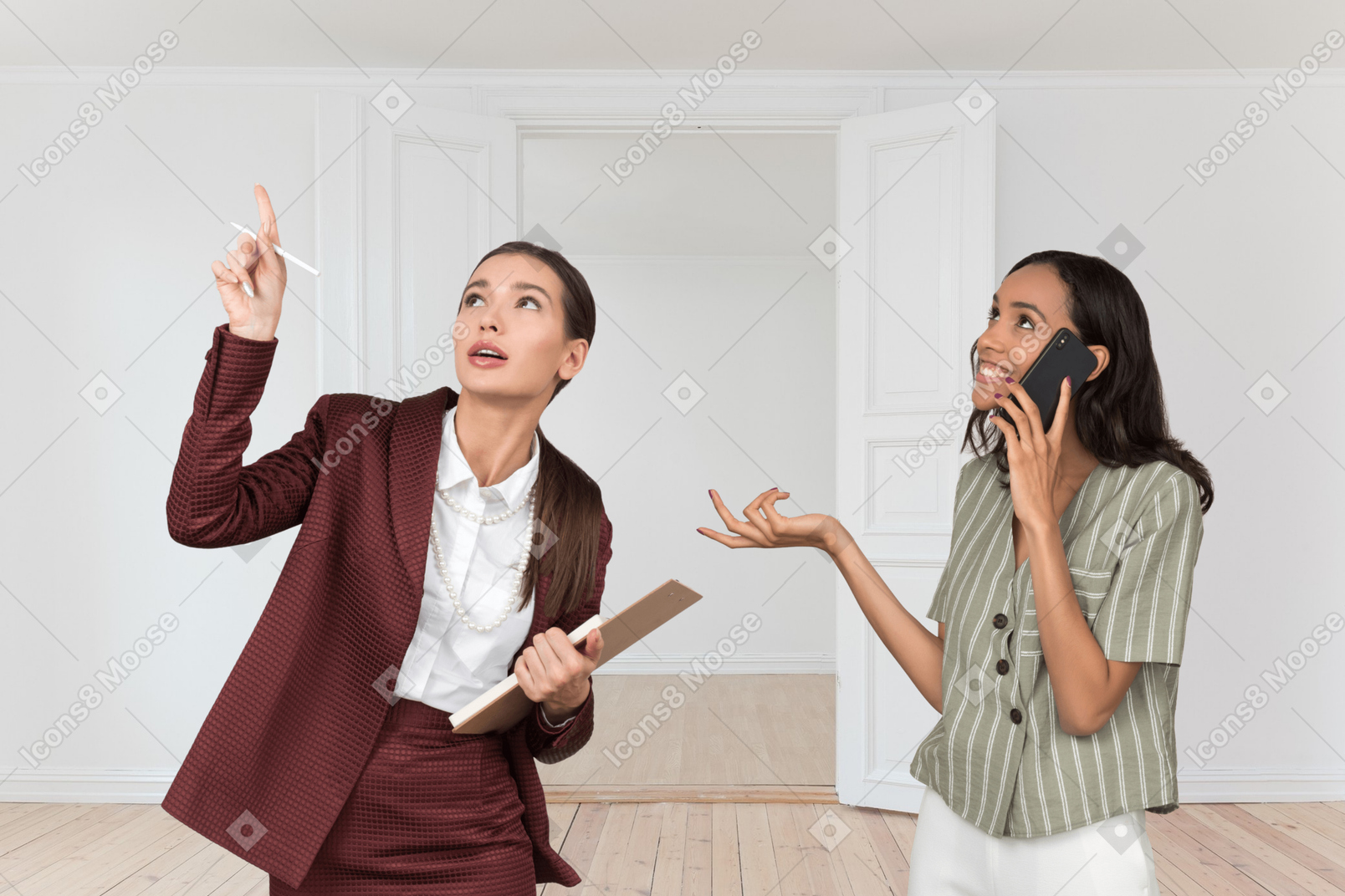 Young woman talking on the phone while realtor showing her something