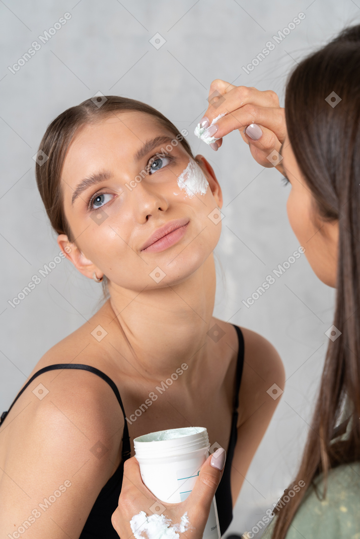 Beautiful young woman getting skin treatment