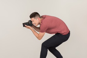 Young guy taking photos with a camera