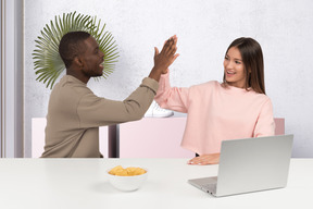 A man and woman giving each other a high five