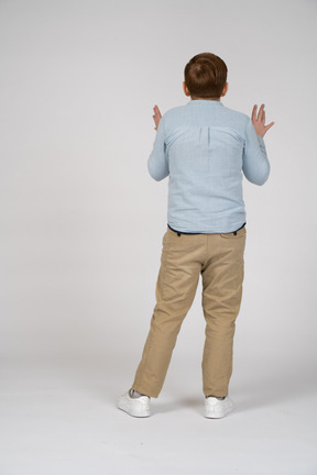 Rear view of a boy explaining something