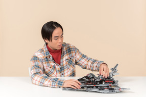 An asian geek guy in a checkered shirt