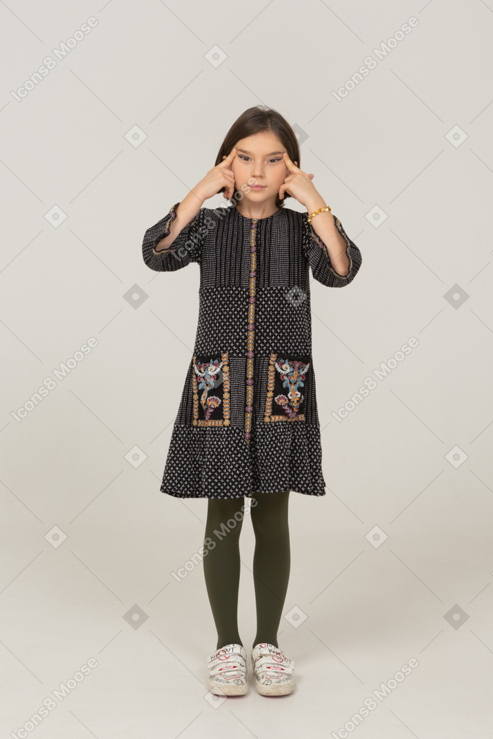 Front view of a little girl in dress narrowing her eyes